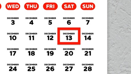 Close-up of the date December 13th marked with a red cursor on the wall calendar 2025