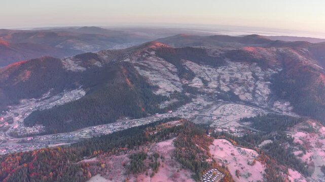 Ukraine, drone, flight in the Carpathians early autumn morning at sunrise near the city of Kosiv. Bright forests and frost of the night frost