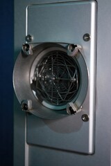 Industrial Heater Vent with Subtle Warmth A close up, abstract shot of an industrial heater vent. Focus on the metal texture and a very subtle, almost imperceptible hint of warm air or light escaping.