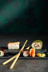 Vielfältige Sushi-Auswahl auf einer dunklen Schieferplatte