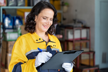 happy senior auto service manager woman working clipboard checking or inspection car in auto shop or service garage .