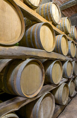 stack of wine barrels in a farm winery in tuscany italy no logos