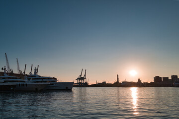 harbor with lighthouse of Genoa at sunset in Italy