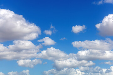 Fototapeta premium Bright blue sky background with fluffy clouds
