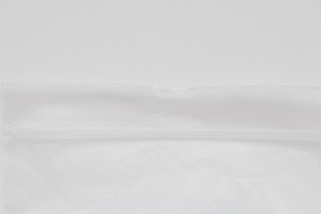 Obraz premium Transparent plastic bag with a zip lock on a white background