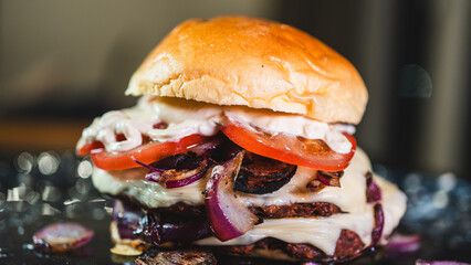 Double decker vegan burger with plant-based patties, vegan cheese, fresh tomato, and red onion. Stacked high on a toasted bun. Perfect for vegan food promotion.