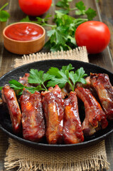 Appetizer roast sliced pork ribs in frying pan