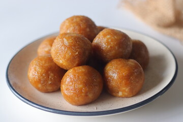 Jackfruit laddus on a rustic burlap backdrop, made with pureed jackfruit, raw sugar and coconut