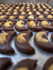 Delicious choco-nut crescent cookies cooling on a baking sheet.
