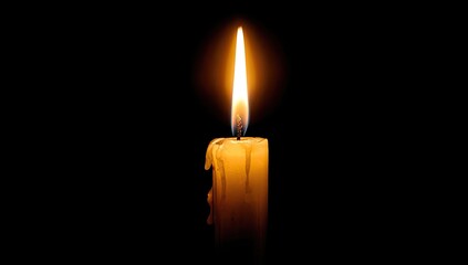 Single candle flame against dark background (1)