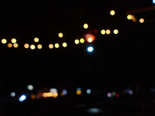 Abstract blurred golden lights on a dark background, creating a warm bokeh effect perfect for festive, dreamy, or night-themed designs © Stock Arza