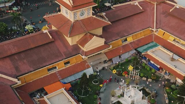 Aerial 4K Drone View of Historic Binh Tay Market Clock Tower, Ho Chi Minh City's Chinatown Landmark
Cholon Chinatown district, showcases a rare blend of traditional Chinese design elements with French