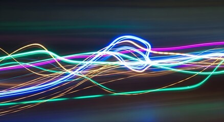 Abstract flowing light trails of vibrant neon colors creating a dynamic and energetic wave pattern against a dark background