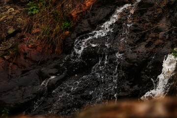 Close-up of waterfall surrounded by autumn colors, soft mist and golden light (Autumn Serenity Collection)