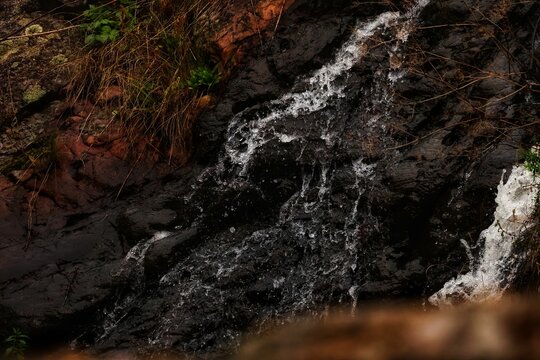 Close-up of waterfall surrounded by autumn colors, soft mist and golden light (Autumn Serenity Collection)