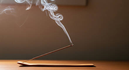 Serene White Smoke Rising from Burning Incense Stick on Wood
A close-up, horizontal shot of a thin, burning incense stick placed in a simple, curved wooden holder resting on a smooth wooden surface