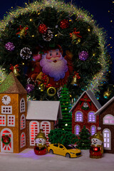 A small Christmas village with a chapel under an Advent wreath