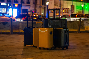 A collection of luggage on a city street.