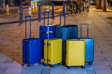 A collection of luggage on a city street.