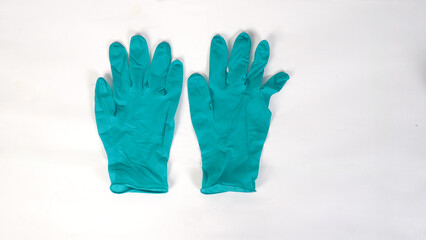 Green latex or nitrile glove on white background.