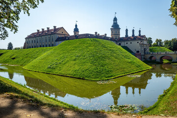 Nesvizh Castle reflecting on water body.