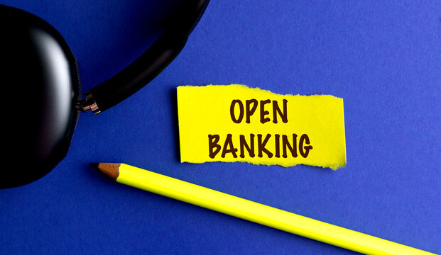 OPEN BANKING text on yellow torn paper on blue background