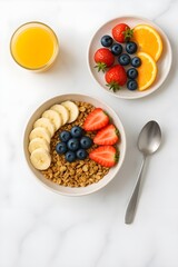 Healthy breakfast with granola bowl, fruits, and orange juice