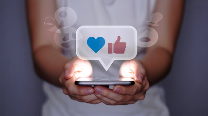 Person holding smartphone displaying social media like and heart