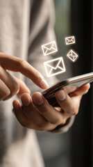 Hands holding smartphone checking email inbox with glowing icons