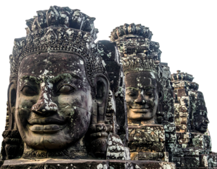 Ancient stone faces stand in weathered structures, aged by time and element, under a bright sky