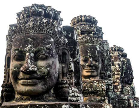 Ancient stone faces stand in weathered structures, aged by time and element, under a bright sky