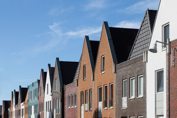 Modern terraced houses in various colors with pointed and flat roofs in the new Vathorst district in Amersfoort.