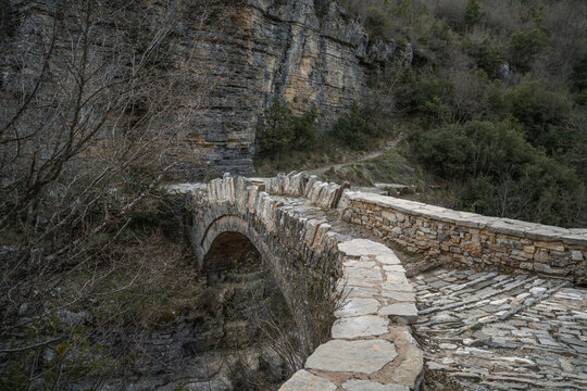 Old small arched stone bridge of Lakou or Loli's, between the micro and megalo Papingo villages during spring
