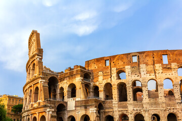 Fototapeta premium Imposing facade of the historic Colosseum in Rome, Italy, showcasing its distinctive architectural layers and timeless beauty. 