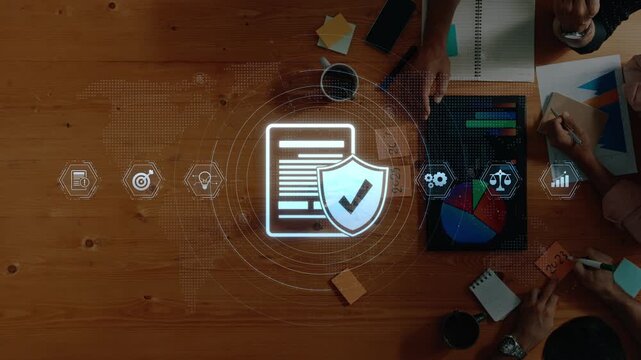 Aerial view of a modern workspace showcasing technology and data protection concepts with charts, charts, and documents on a wooden desk facilitating collaboration. Raster