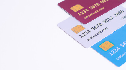 Three Fictional Credit Cards in white background with copy space. Minimalist design for banking advertisements, financial options, or secure digital payment.
