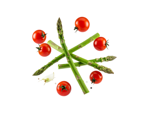 Asparagus, tomatoes, and garlic clove arranged on a black background in a star shape
