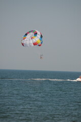Colorful parasailing adventure over blue ocean water
