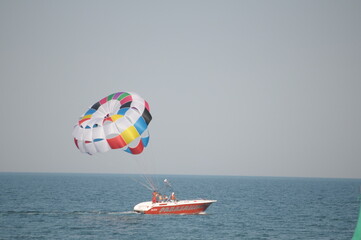 Colorful parasailing adventure over blue ocean water