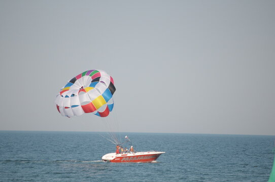Colorful parasailing adventure over blue ocean water