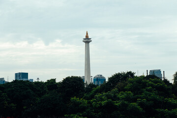 Jakarta, Indonesia - January 29, 2023. View of Indonesia National Monument(Monumen Nasional Monas) from distance from Istiqlal Mosque. Tip of Monas. Top of Monas