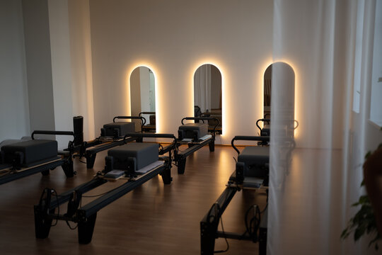 Serene pilates space, peaceful pilates environment featuring soft lighting and organized reformers