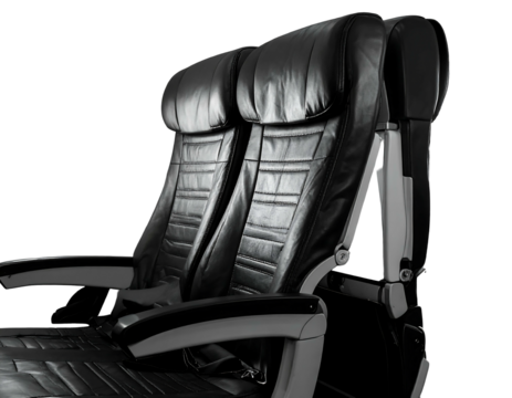Close-up of two black leather airplane seats on a black background, showing plush design and comfort
