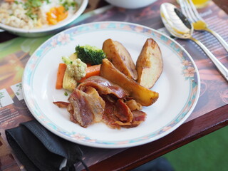 Hotel Breakfast Plate with Roasted Potato Wedges, Ham, Broccoli, Carrots, and Corn in Phuket, Bangkok