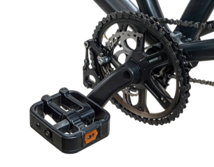 Close-up shot of a black bicycle crankset, pedal, and chain on a black background