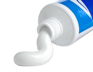 Close-up white paste extruded from a tilted blue & white tube, set against a stark black background