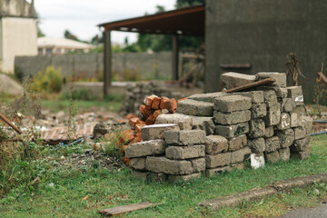 Stacked Clay Bricks on Green Grass