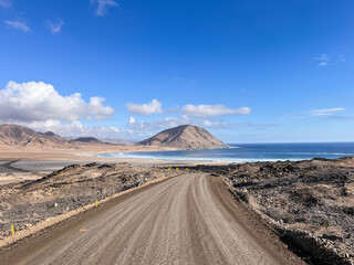 Beautiful scenic landscape view and dirt road going through  National Parc Pan de Azúcar in Chile. This natural area showcases unique desert flora, dramatic cliffs, beaches,  pristine coastal scenery