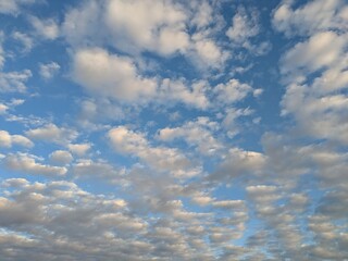 Fluffy White Clouds in Bright Blue Sky
