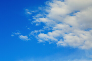 Beautiful blue sky with fluffy white clouds on a bright sunny day